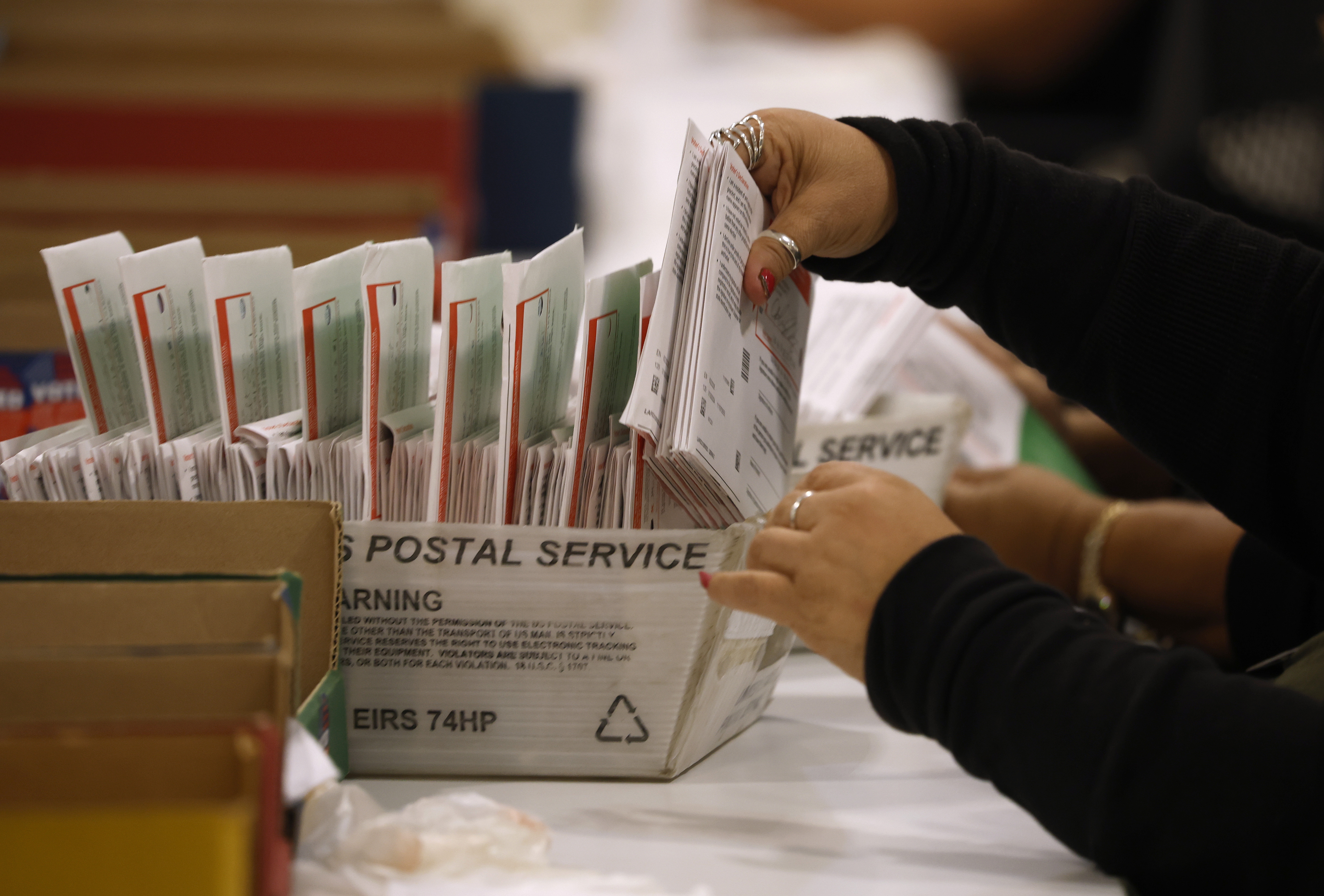 An election worker processes mail-in ballots in June in Industry, Calif.